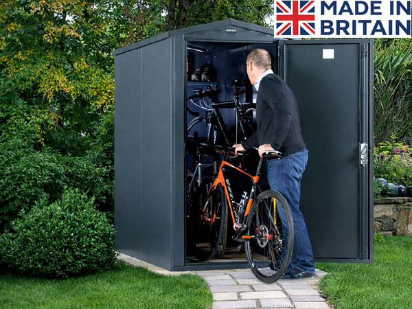 Man placing a bike in a storage shed. The shed provides secure outdoor storage for bicycles.