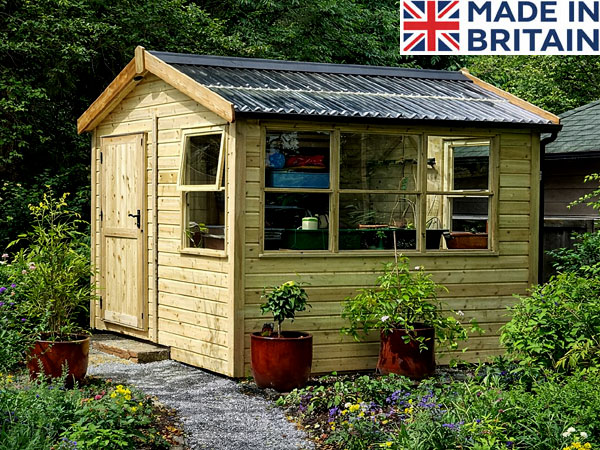 A wooden potting shed with large windows and a door, surrounded by potted plants.