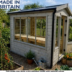 A garden room with glass windows and doors, surrounded by plants and flowers.