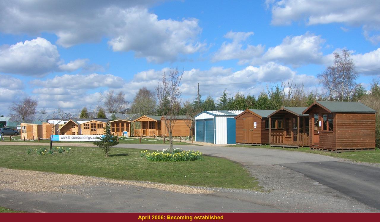 Wooden garden buildings on a sunny day A row of wooden garden sheds and chalets. A selection of outdoor wooden structures