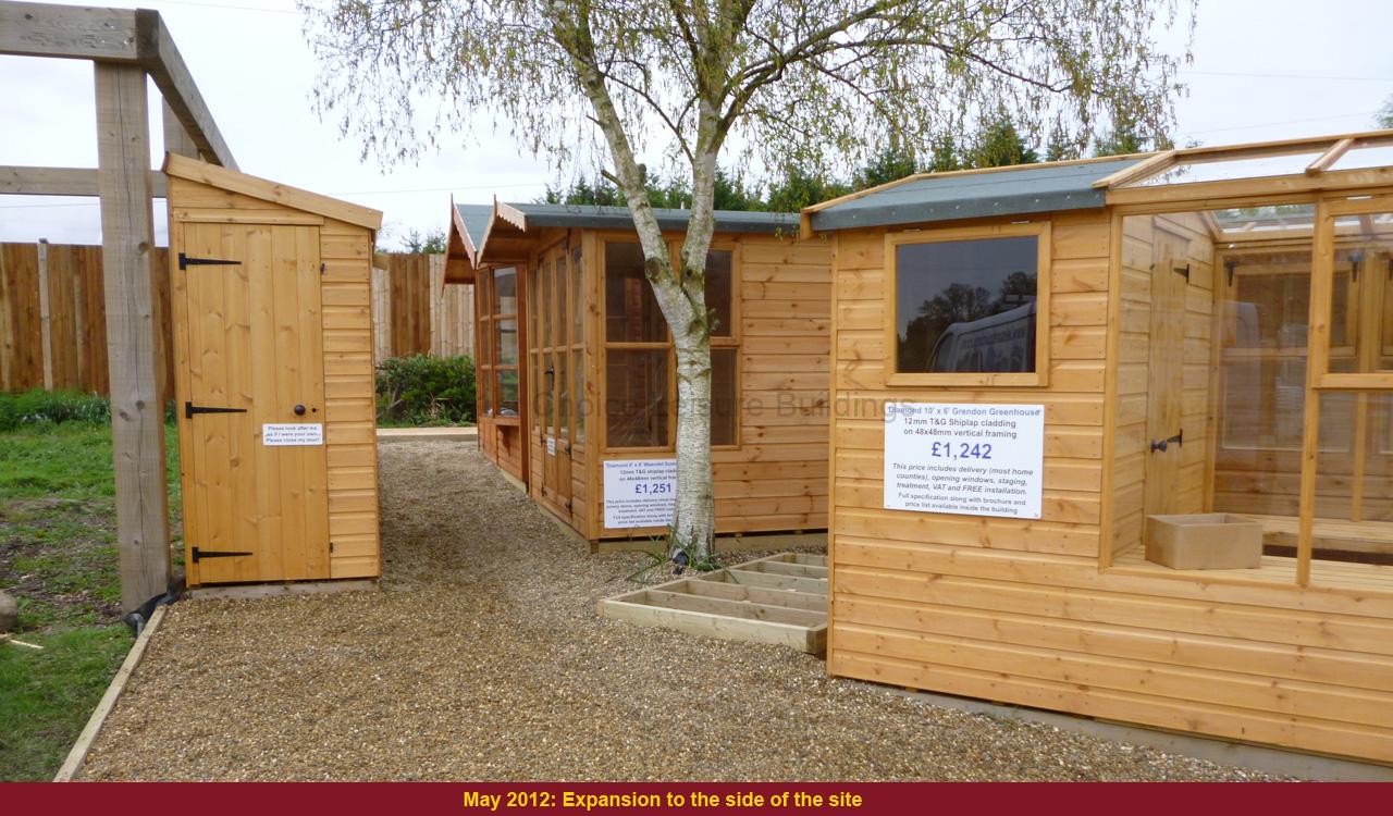 Wooden garden buildings for sale UK A row of wooden garden sheds and greenhouses for sale