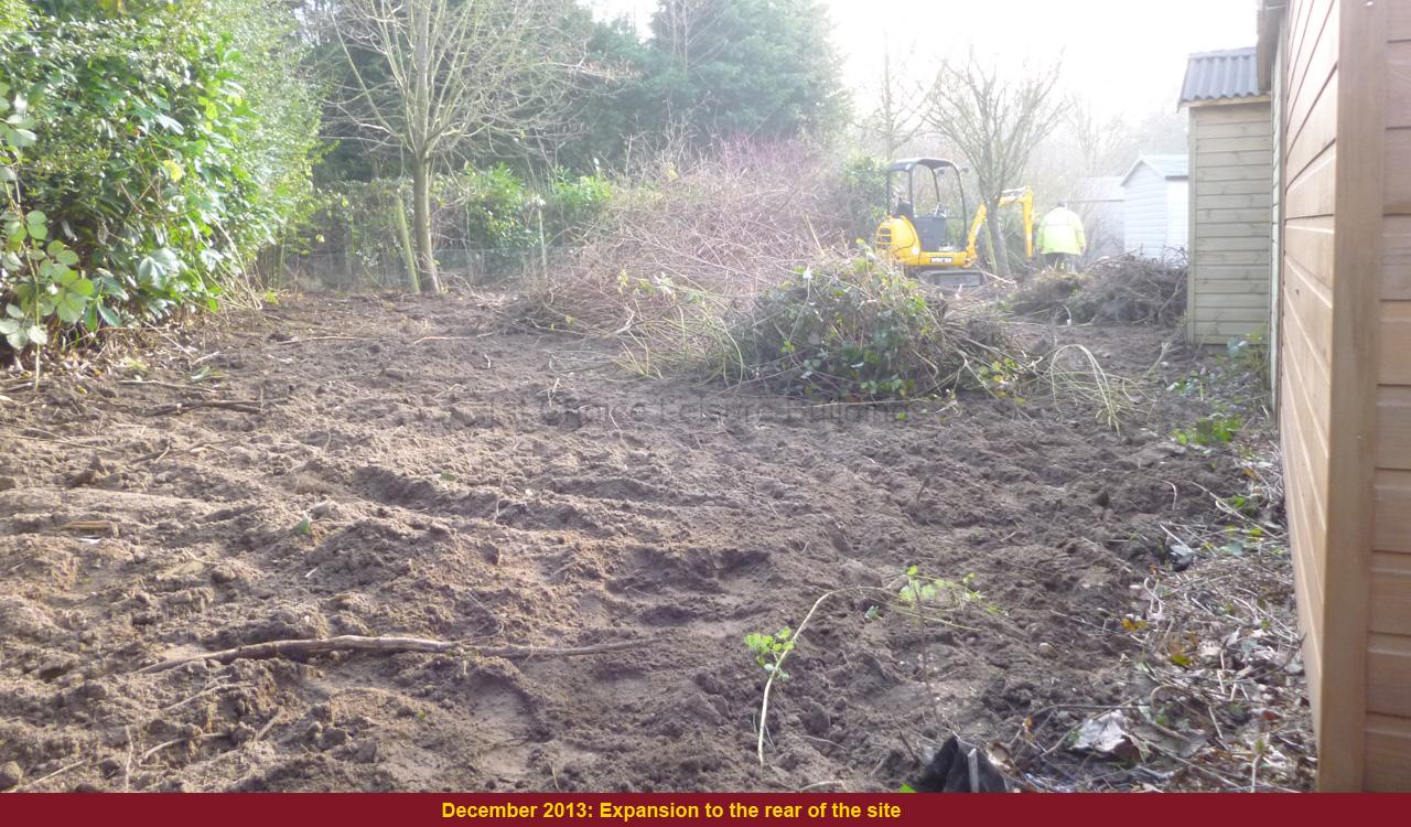 Garden site preparation with excavator Excavator in a garden site, clearing land