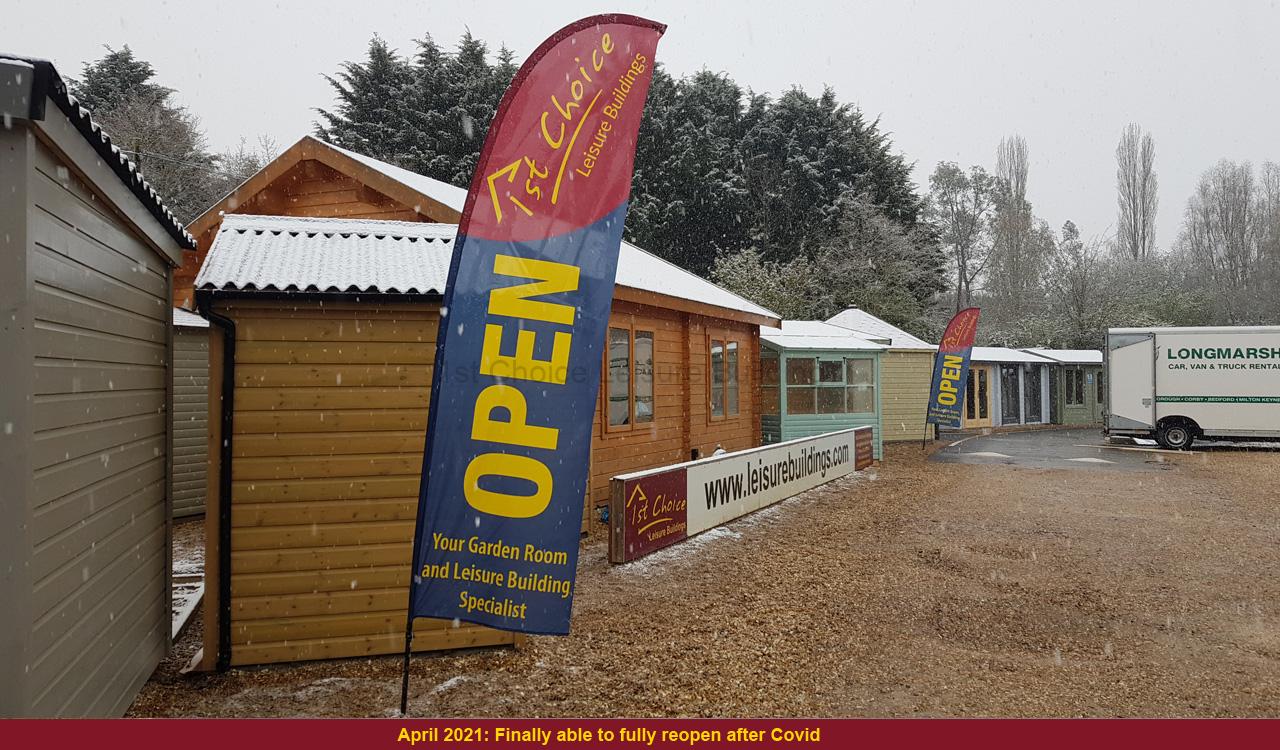 Garden buildings UK open for business Open sign in front of garden buildings