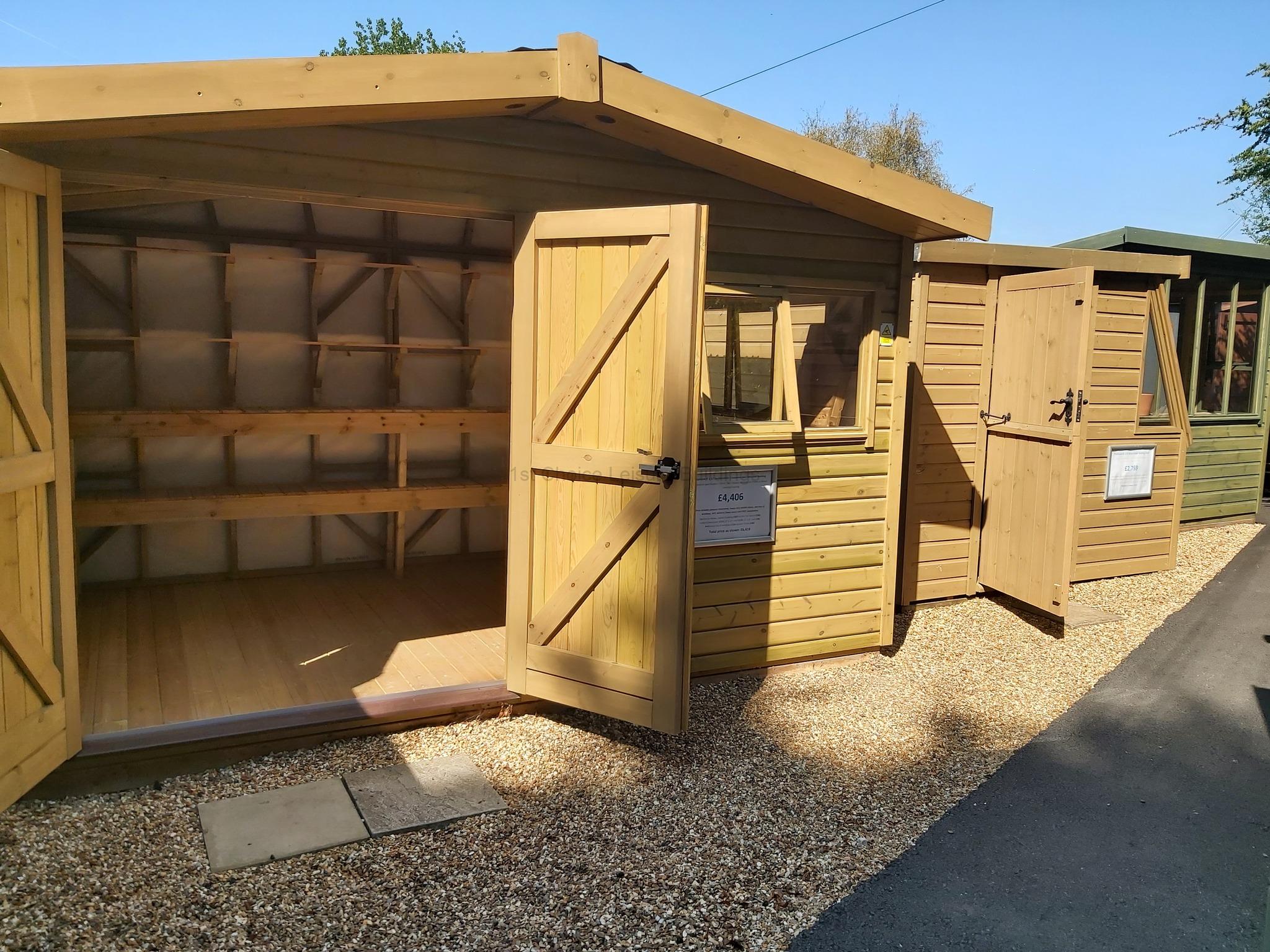 Wooden garden sheds with open doors A row of wooden garden sheds with open doors