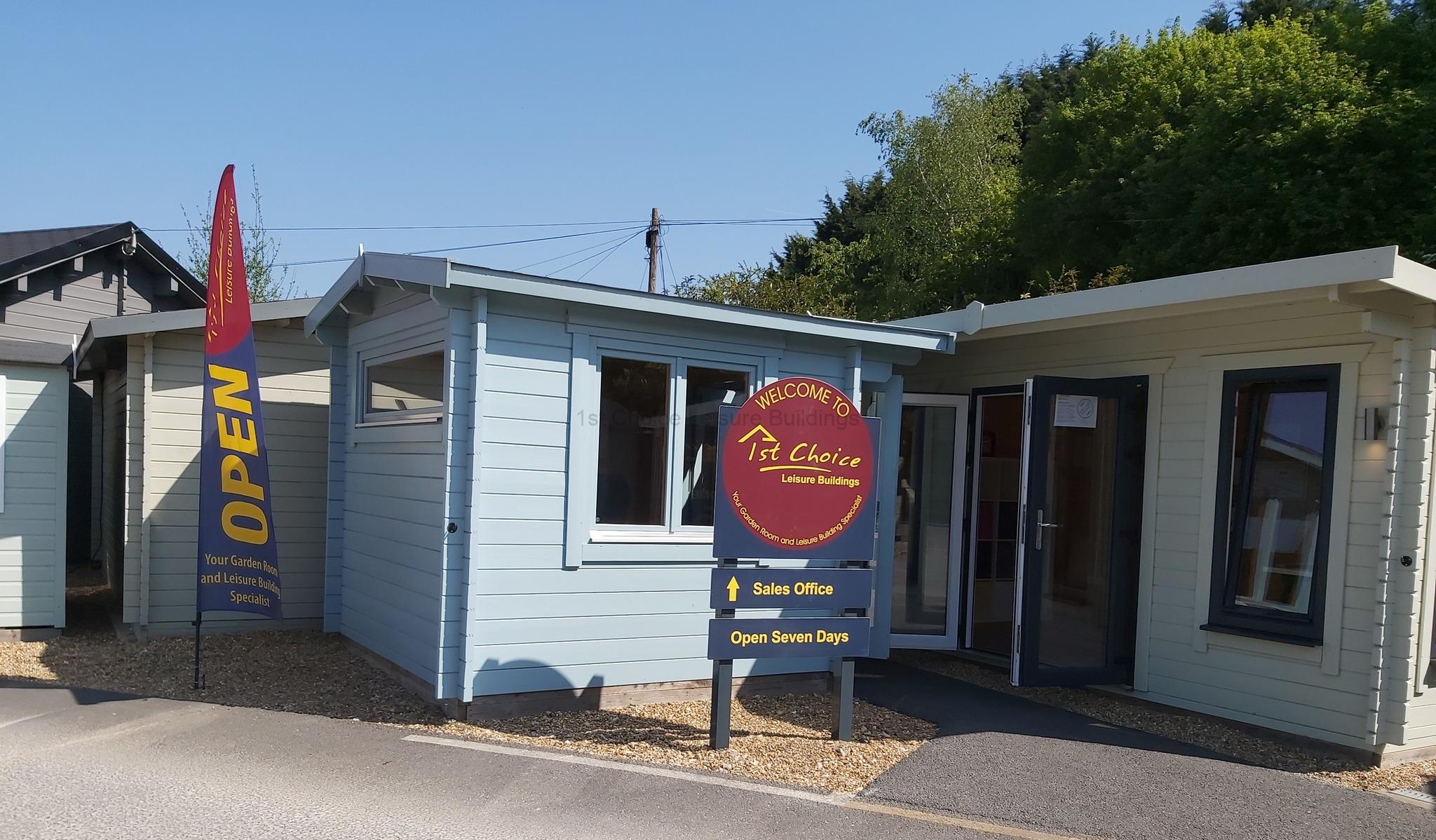 UK Garden Buildings Sales Office A small blue and white garden building with an open sign
