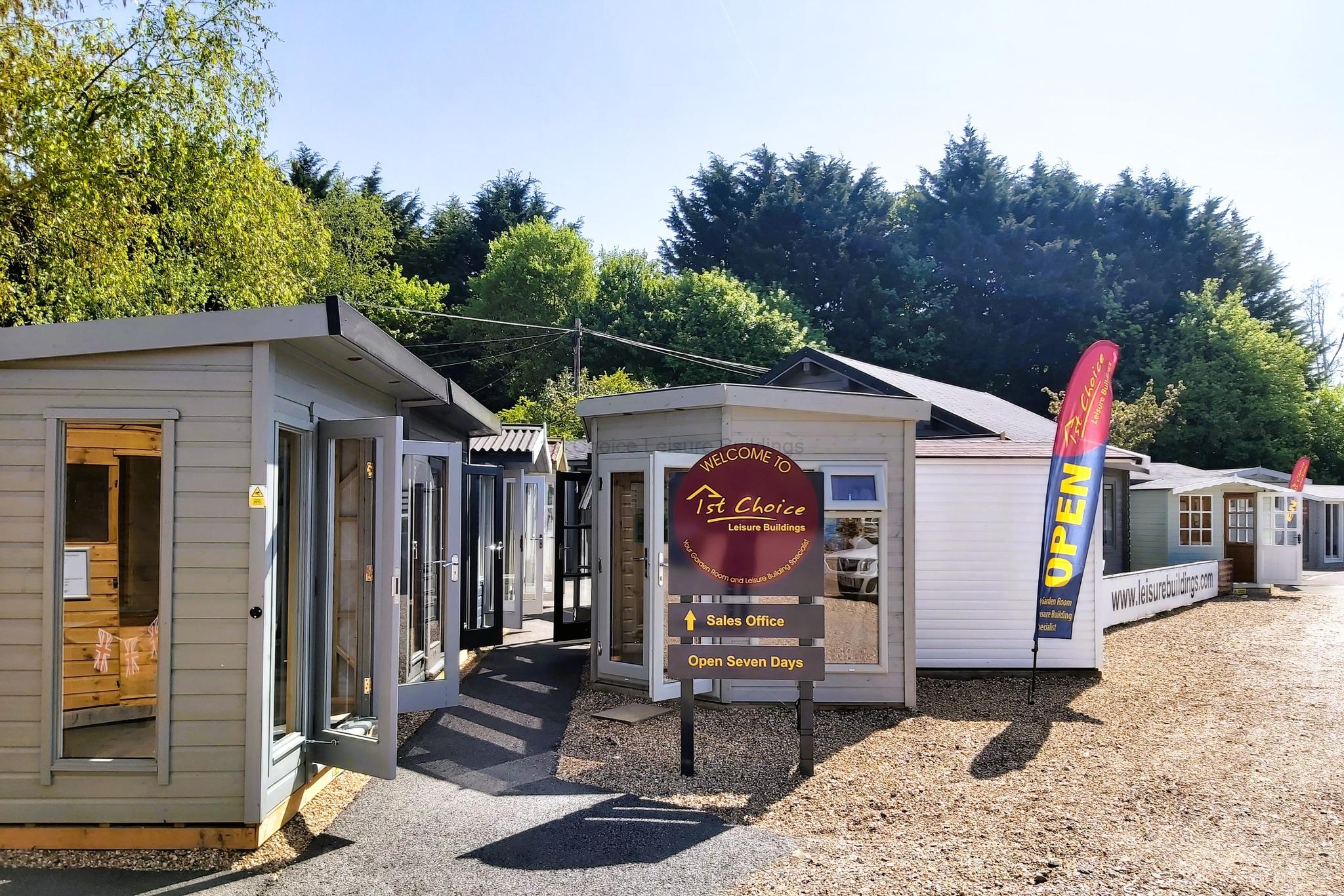 Garden buildings on display at 1st Choice Leisure A row of small garden buildings on display. A sign reads Welcome to 1st Choice Leisure Buildings.