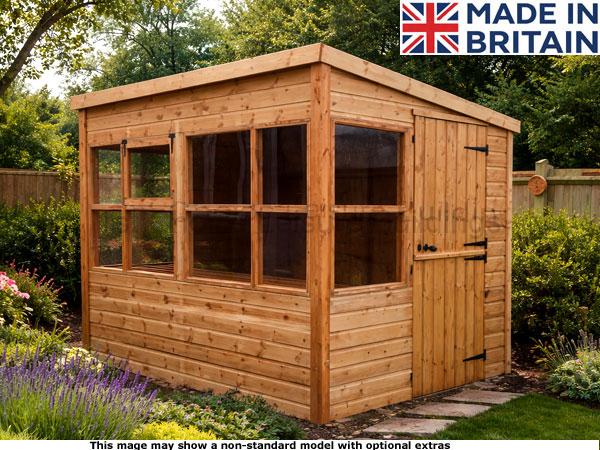 Diamond Portslade Shed 1 A wooden potting shed with large windows and a door, set amidst a garden.