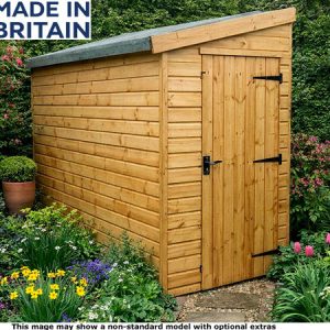A wooden garden shed with a grey roof and black hardware, surrounded by flowers and plants. The shed is made of light-coloured wood.