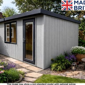 A grey Royal Bletchley pent garden room with a black door and windows. A beautiful garden surrounds the shed.