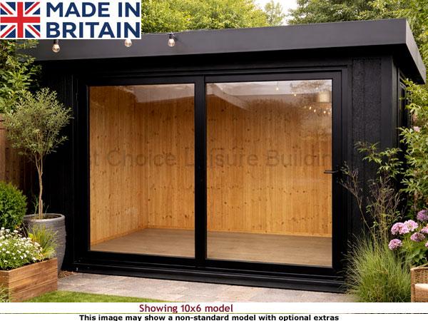 Royal Denham 12x12 Garden Room 1 A modern black Royal Denham Garden Room with large windows and wooden interior, surrounded by lush greenery and flowers.