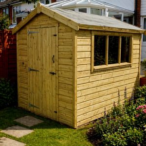 A wooden garden shed with a window and single door in a backyard garden. The shed is made of light-coloured wood and has a sloping roof.
