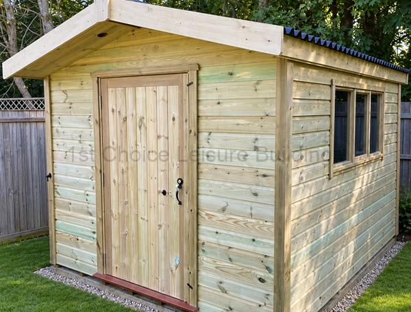 10x8 wooden workshop with a door, side windows, and a gravel base in a fenced yard.