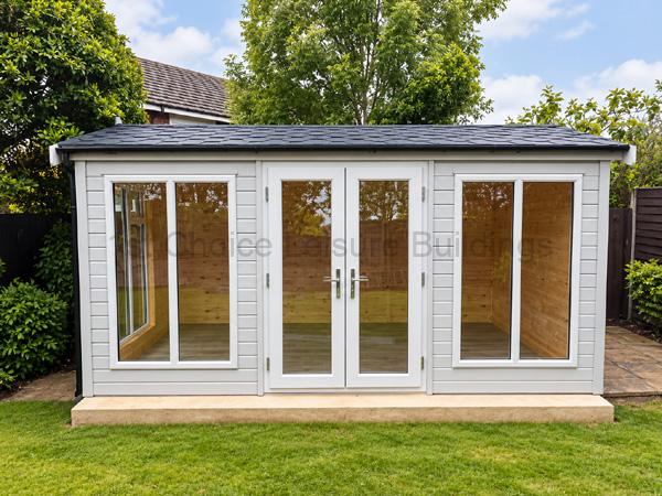 Light gray garden room with glass panels, double doors, on a raised concrete base in a backyard.