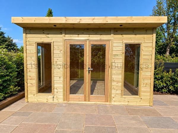 Larg wooden garden room with large glass doors and side windows on a tiled patio.